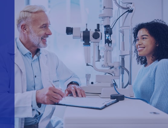 Doctor talking to a patient while writing notes